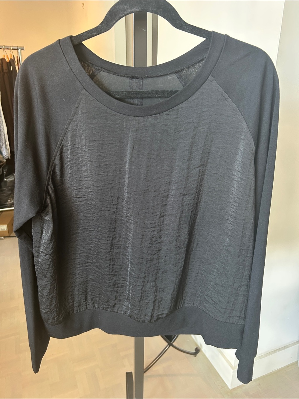Black Textured L/S Top. Ribbed sleeves and neckline satin body with back opening